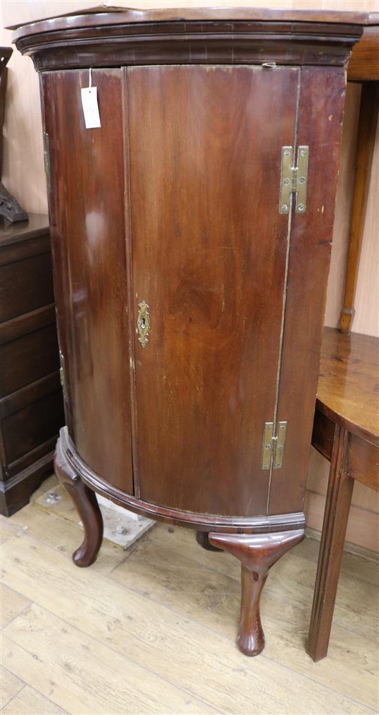A George III mahogany bowfront corner cabinet on later cabriole legs W.78cm